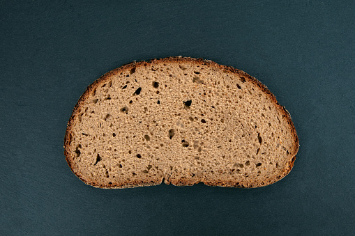 Slice of Rye Bread isolated on dark background