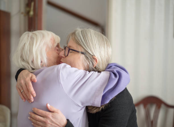 istock Sad Mother and daughter hugging each other goodbye. 1155747233