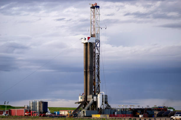 istock Fracking Drilling Rig at Dusk or Dawn on the Eastern Colorado plains under a dramatic sky 1155748406