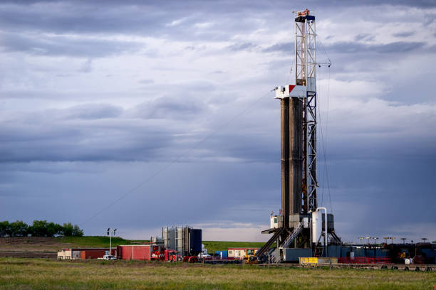 istock Fracking Drilling Rig at Dusk or Dawn on the Eastern Colorado plains under a dramatic sky 1155748454