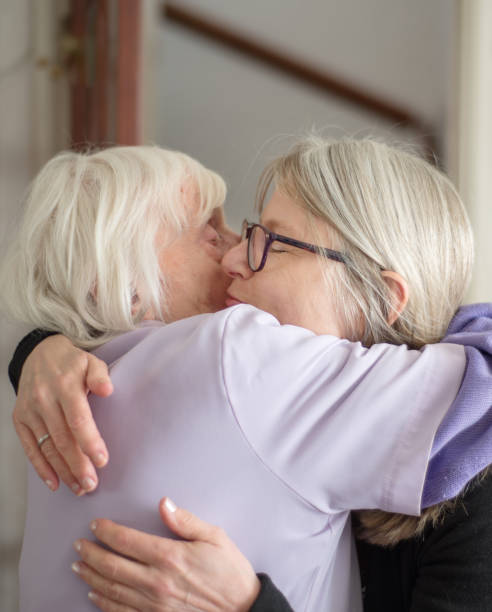 istock Sad Mother and daughter hugging each other goodbye. 1155748697