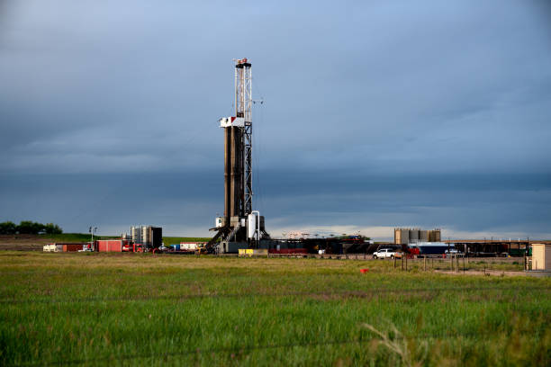 istock Fracking Drilling Rig at Dusk or Dawn on the Eastern Colorado plains under a dramatic sky 1155749042