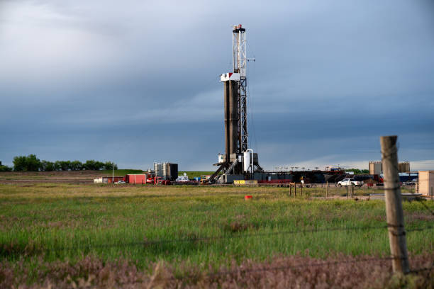 istock Fracking Drilling Rig at Dusk or Dawn on the Eastern Colorado plains under a dramatic sky 1155749055