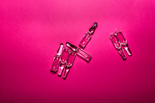 Ampules on a pink background stock photo