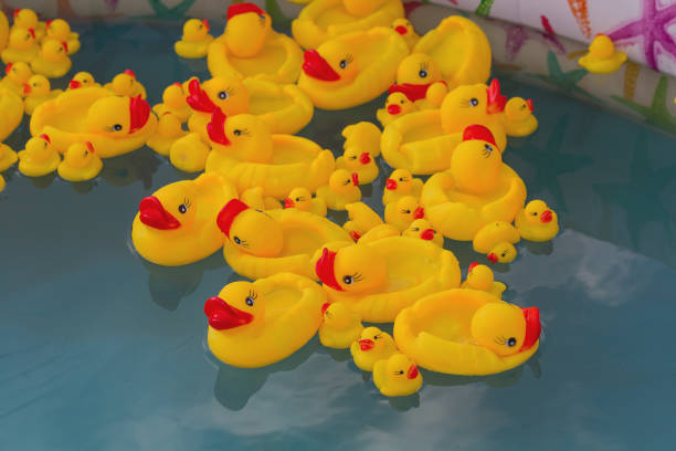 istock Many rubber yellow toy ducks floating in children's pool close up 1155749699