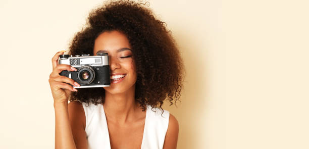 istock Young female photographer with old camera. 1155750836