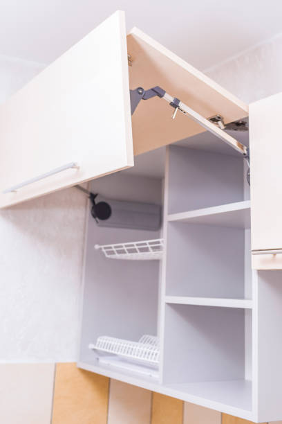 istock Lines of Empty Kitchen Cabinets at Renovated Kitchen. Vertical Image Orientation 1155752711