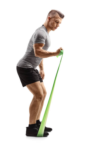istock Young muscular guy exercising with an elastic band 1155752757