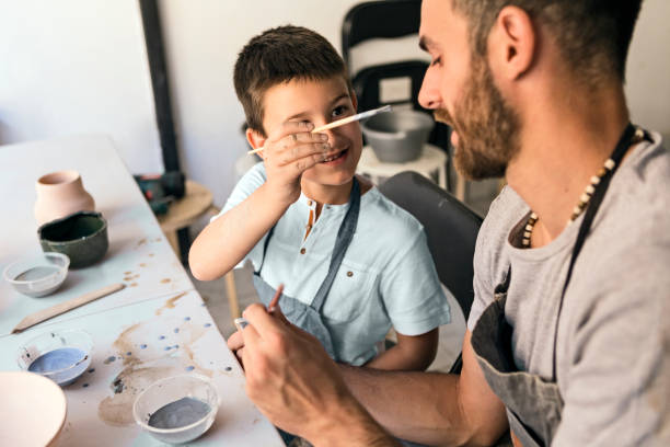 istock Father and son working on art together having fun 1155753003