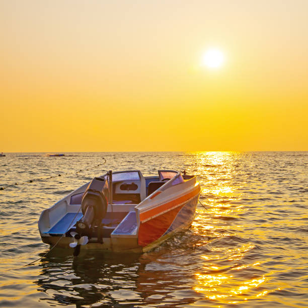 istock Sea and boat at sunset 1155754512