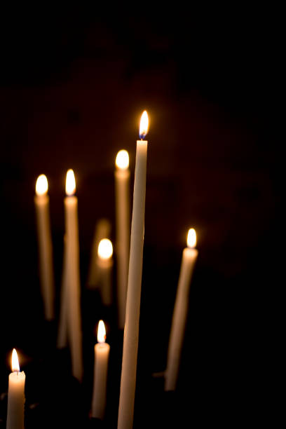 istock Many Lit Church Candles on Black Background 1155756801