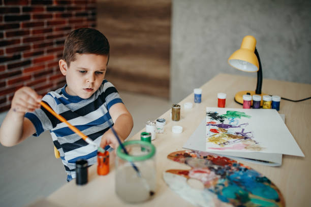 istock Boy draws in water colors 1155758173