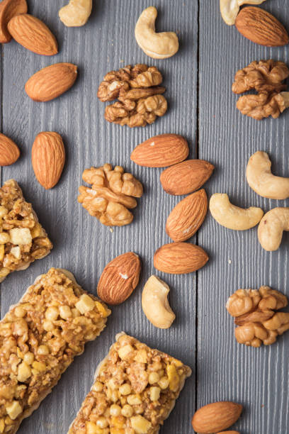 istock Granola cereal flakes with nuts on gray wooden table. Top view. 1155763571