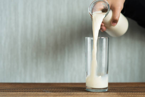 istock pouring milk into a drinking glass 1155765948