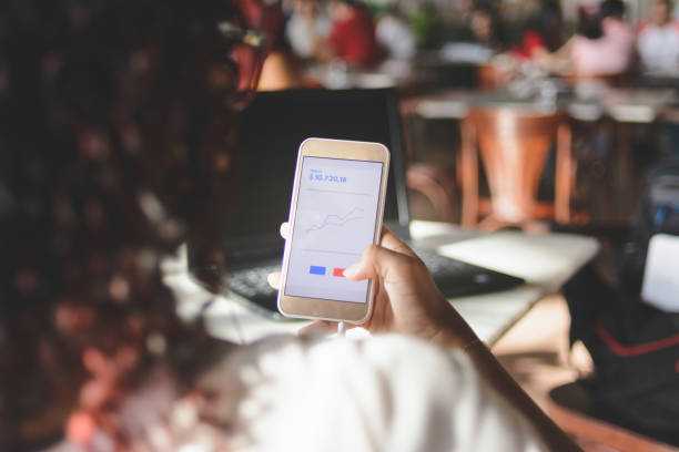 istock Woman using mobile financial app on smartphone 1155769636