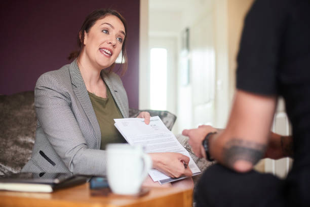 istock Mortgage advisor showing client where to sign 1155771014
