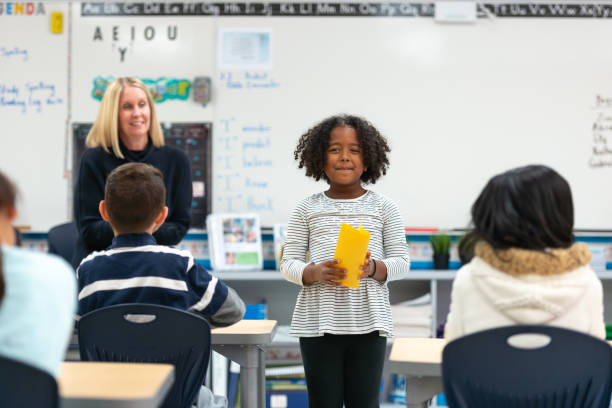 istock Young African Girl Presenting to Her Class 1155771727