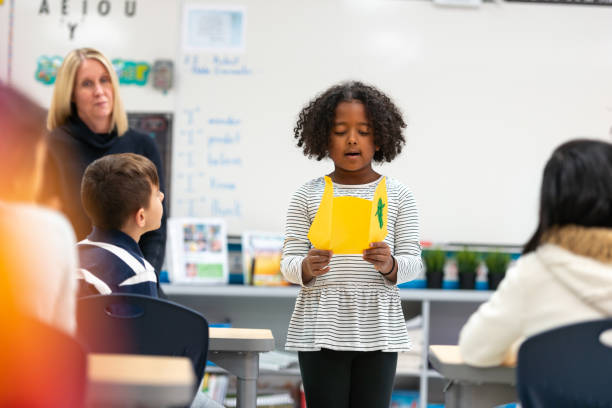 istock Young African Girl Presenting to Her Class 1155771729