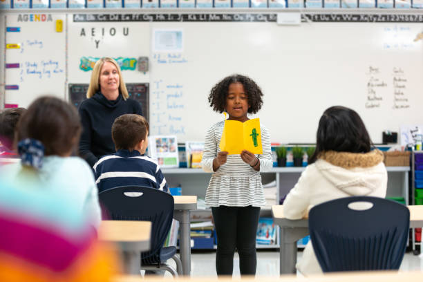 istock Young African Girl Presenting to Her Class 1155771731