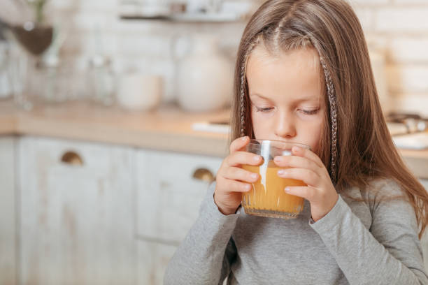 istock organic fruit nutrition girl drinking orange juice 1155772221