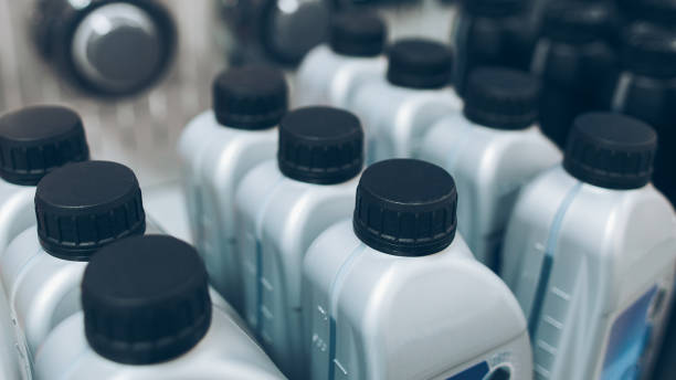 auto detailing supplies showcase motor oil Auto detailing supplies showcase. Closeup of gray plastic bottles with motor oil. car for sale stock pictures, royalty-free photos & images