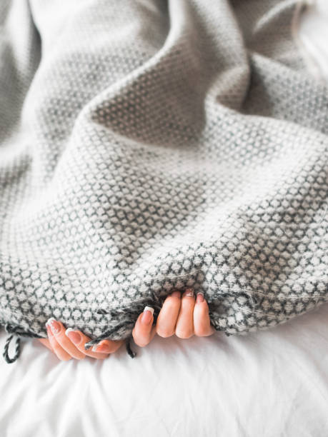 istock introvert lifestyle woman hiding problems blanket 1155772355