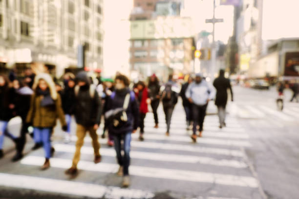abstract background image of defocused people walking on busy street