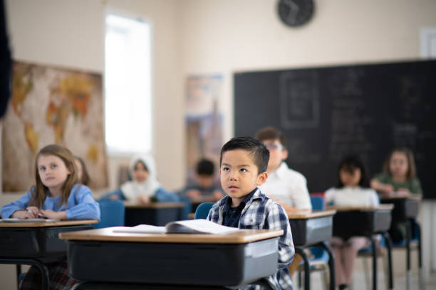 istock Students Listening to Their Teacher Speak 1155772601