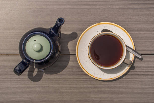 istock Cup of tea with teapot on a wooden table. 1155772692