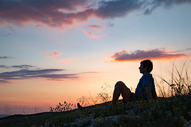 istock Silhouette of a person against sunset. 1155772741