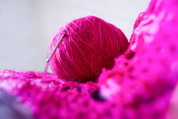 istock ball of wool with crochet pink 1155774564