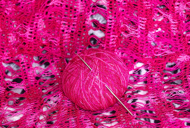 istock ball of wool with crochet pink 1155774827