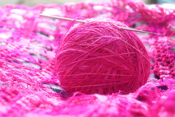 istock ball of wool with crochet pink 1155774842