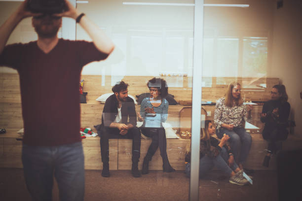 istock Young man looking with VR in front of the glass 1155775686