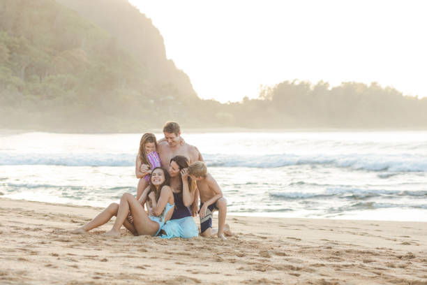 istock Family posing together on the beach 1155775721