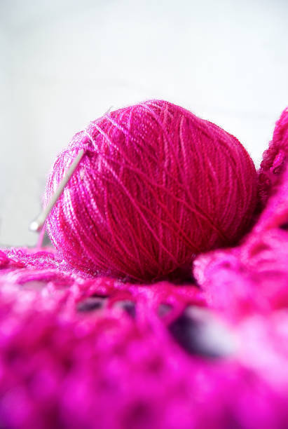 istock ball of wool with crochet pink 1155776467