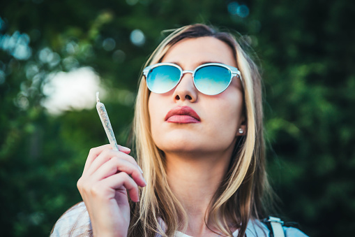 Young woman with weed joint