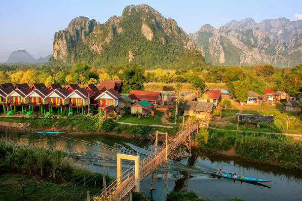 Row of tourist bungalows along Nam Song River in Vang Vieng, Vientiane Province, Laos stock photo