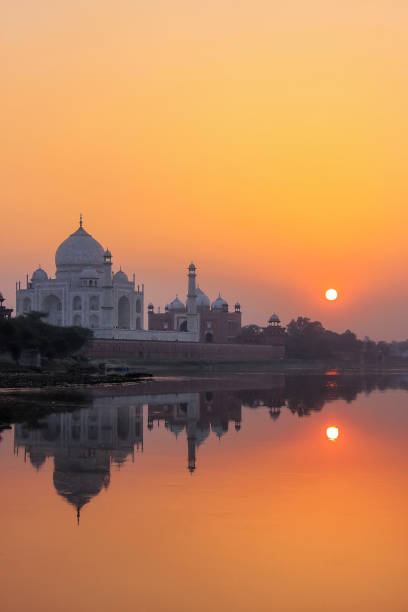 istock Taj Mahal reflected in Yamuna river at sunset in Agra, India 1155779092