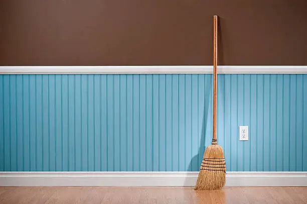 Photo of Corn whisk broom standing in empty room