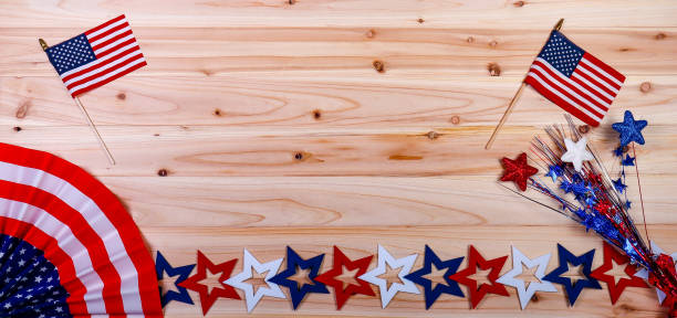 istock American flag, banner and stars on a cedar board background 1155779645