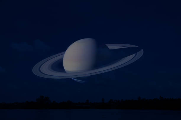 istock Saturn on night sky back silhouette mountain and river 1155797052