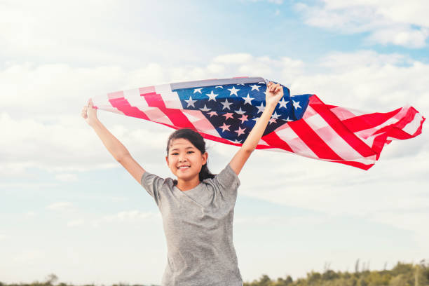 happy asian little girl with american flag usa celebrate 4th of july - child flag fourth of july little girls imagens e fotografias de stock