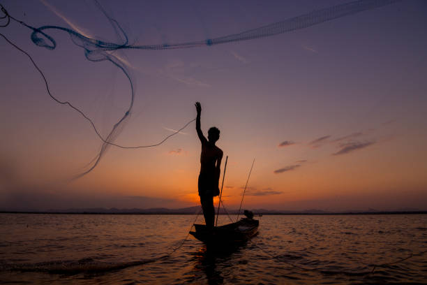istock throwing fishing net during sunset 1155803278