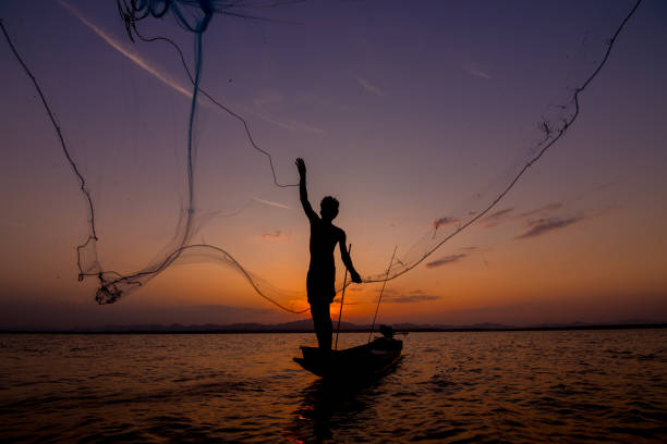 istock throwing fishing net during sunset 1155803303