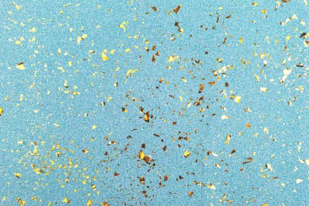 istock Golden foil confetti on blue glitter background. 1155803385