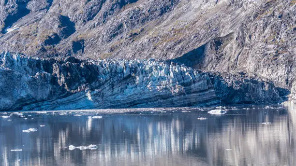 Rockface/rock face of Johns Hopkins Glacier & floating ice, Glacier Bay National Park and Preserve Alaska, a 12 mile long glacier in the tidewater inlet basin. Close up details captured October 2017.