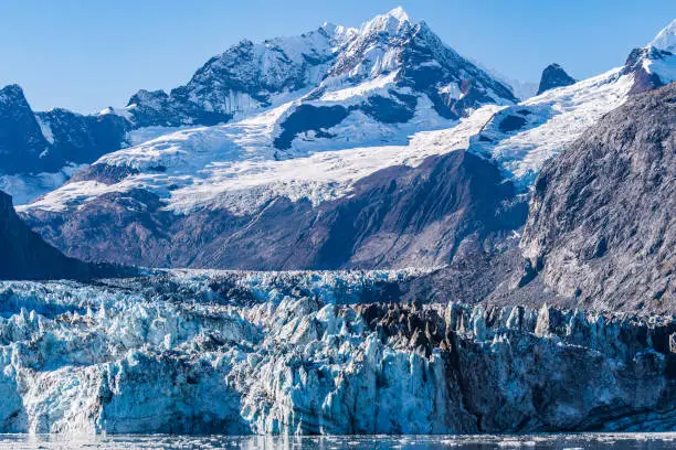 Johns Hopkins Glacier, a 12 mile long glacier in Glacier Bay National Park and Preserve, Alaska. Captured October 2017. Mount Orville and Mount Wilbur ice/snow covered peak mountains in background.