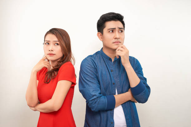 Young angry couple in love standing back to back Young angry couple in love standing back to back former photos stock pictures, royalty-free photos & images