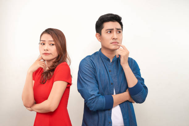 istock Depressed couple after quarrel on white background 1155810120